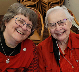 ENews story Donor Advised Fund image. Two sisters sitting together and smiling.