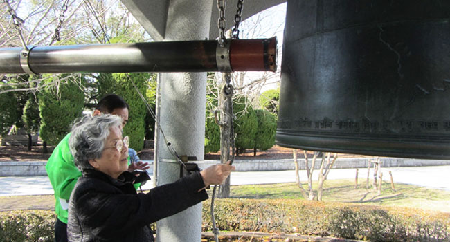 Sister Ruth Mori ringing the Bell of Peace located in Hiroshima Peace Memorial Park.  This park is located at site where the first atomic bomb exploded on August 6, 1945 and is dedicated to remembering the victims and promoting world peace.  