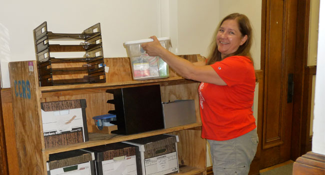 Notre Dame of Elm Grove, Elm Grove, Wisconsin is starting the process of moving and boxing up. Jayne Feucht, from the Finance Department, is packing boxes as seen in this photo. 