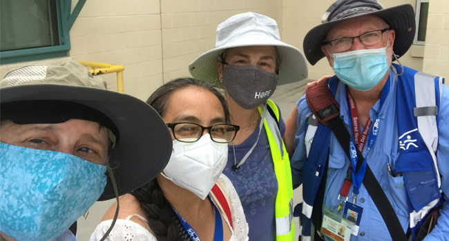 Sister Stephanie Spandl shares a reflection of her trip to the border. This photo has four volunteers posing with masks. 
