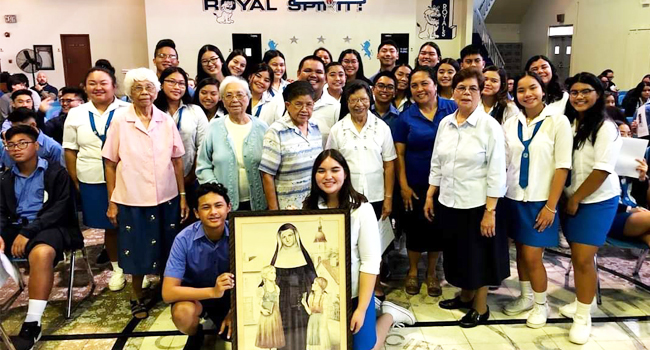 The students of Notre Dame High School in Guam gather for a large group photos with sisters and staff. 