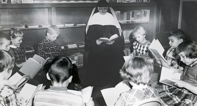 Historical photo of Sister Lillian Nohava with classroom reading