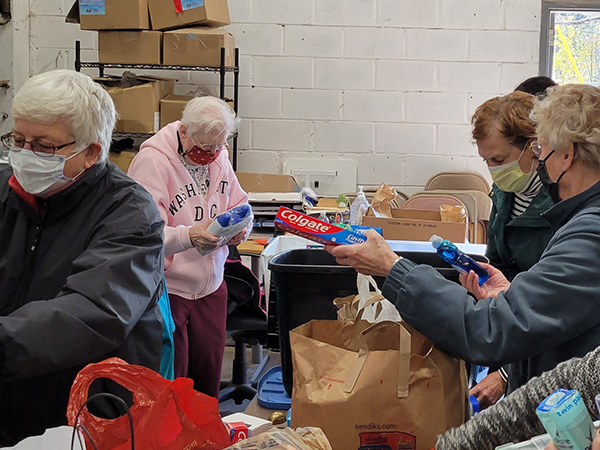 Volunteers sort personal items for distribution