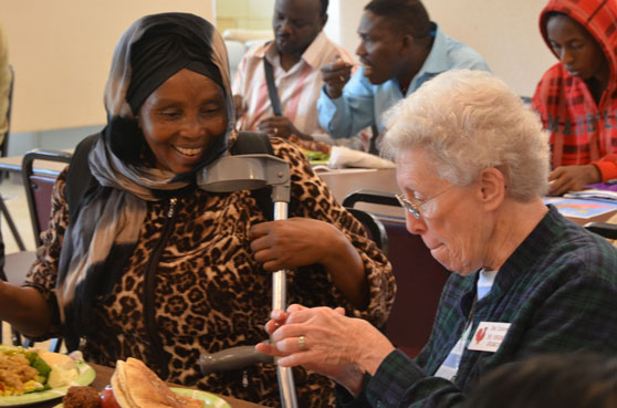 Sister Virginia Grumich chats with an immigrant from the Congo at the International Institute Luncheon