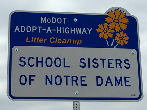 A newly installed sign identifies the School Sisters of Notre Dame as the group responsible for cleaning the section of road between I-255 and Telegraph Road.
