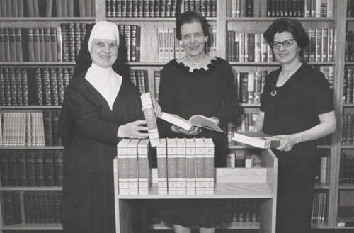 Sister Judith Svoboda and teachers look at encyclopedias at Trinity High School in Dickinson, North Dakota. 