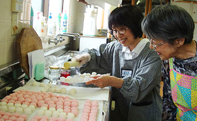 SSND associates Yoko Kubo and Kazuko Maruzumi prepare sweets to share with those attending a concert for tsunami victims.       