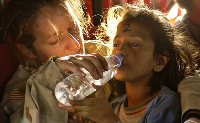 Humanitarian aid giving water to a child in need
