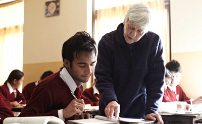 Sister Barbara Soete teaches a student at Notre Dame School in Nepal.