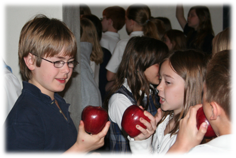 Students enjoying an apple treat.