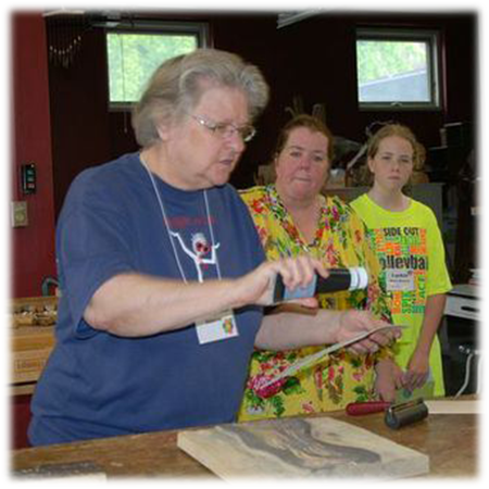 Sister Mary Ann Osborne demonstrating her wood carving skills