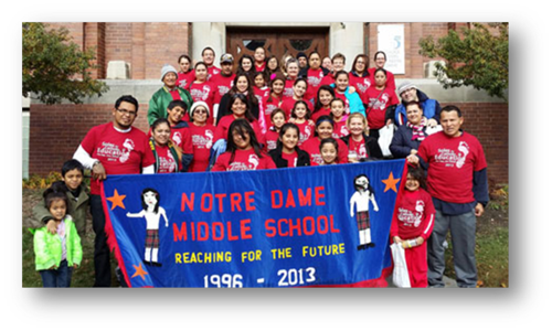 The Notre Dame Middle School team posed for a photo with their school banner which members carried at the Soles for Catholic Education Walk held in Milwaukee on All Souls Day.