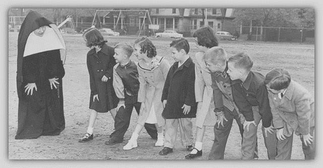 Historical photo of a teacher and students getting ready for a foot race outside. 