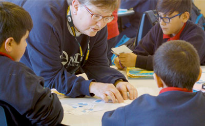 Sister Judy Fleisner reviews a math project with studenta at Notre Dame School of Milwaukee