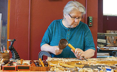 Sister Mary Ann Osborne working in her Wood Carvings studio located at Our Lady of Good Counsel in Mankato, Minnesota. 