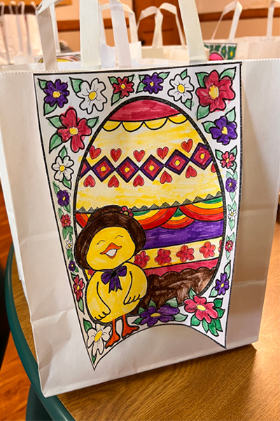St. Raphael the Archangel (SRA) parish in St. Louis and the two gifts they donated to the School Sisters of Notre Dame (SSND) this Lent season. This photo features a gift bag with a colored Easter image. 