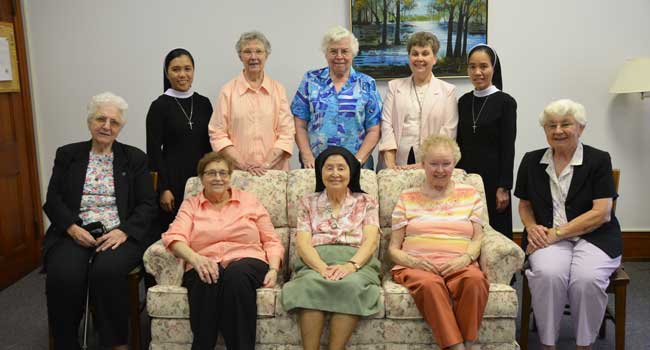 Two visiting Vietnamese sisters were happy to take a photo with their teachers in St. Louis.