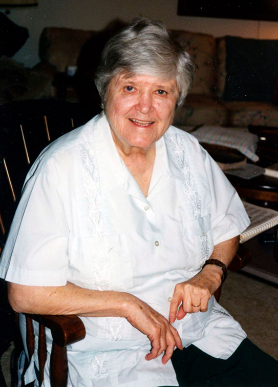 Siste Margaret Ellen Traxler sitting in a rocking chair.