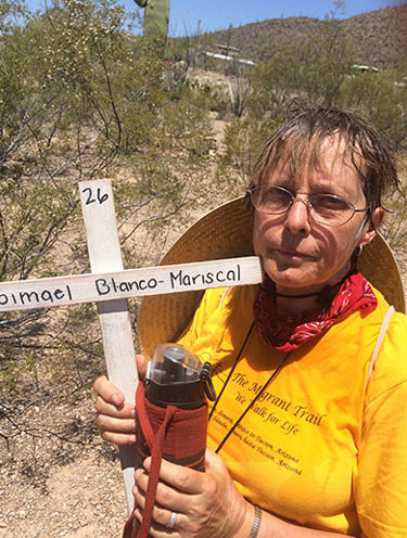 Sisters Lucy Nigh and Judy Bourg participated in a 75 mile Migrant Trail Walk in June 2017.  Sister Lucy is holdin gup a crass and name of someone who died on the migrant trail. 