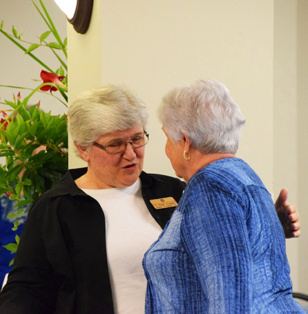 Sister Irene Dohmen and a donor embrace, saying hello, during the 2019 Mass of Appreciation at Our Lady of Good Counsel in Mankato, Minnesota. 