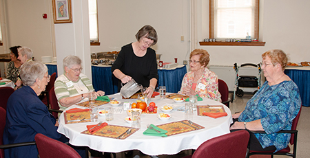 Sisters and donors sit and prepare for a lunch during the 2019 Mass of Appreciation at Sancta Maria in Ripa in St. Louis. 