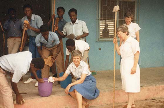 Sister Joan Shaefer has been to many areas of the world in her ministry work. This image is of her and another sister and some local workers cleaning the front steps in Ghana, Africa. 
