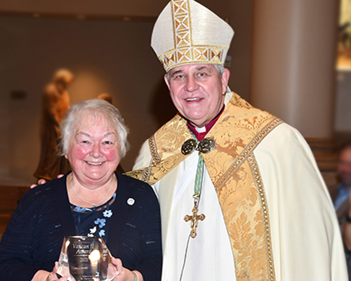 Sister Marianne Kempa and the Archbiship of Milwaukee are posed with the Vatican II Award Sister Marianne recived in the Service to the Church category.