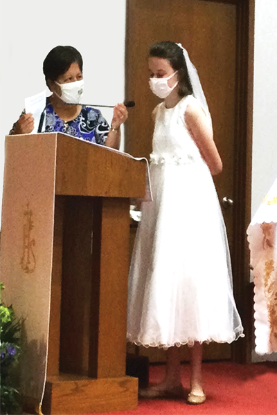 Carmen Fernandez, prinipal of Noter Dame School of Dallas, shares her story of leadership and mentorship with Sister Dawn Aches. This photo is of Carmen and a for first confirmation.
