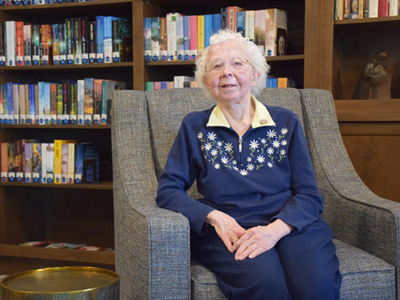 Sister Jackie Buckley sitting in the library at Trinity Woods on the Mount Mary University campus in Milwaukee. 