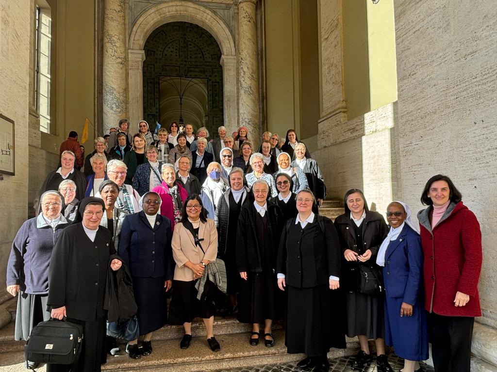 Pope Francis meets with SSND at the 25th General Chapter. Photo of SSND delegates in the entrance to Vatican.
